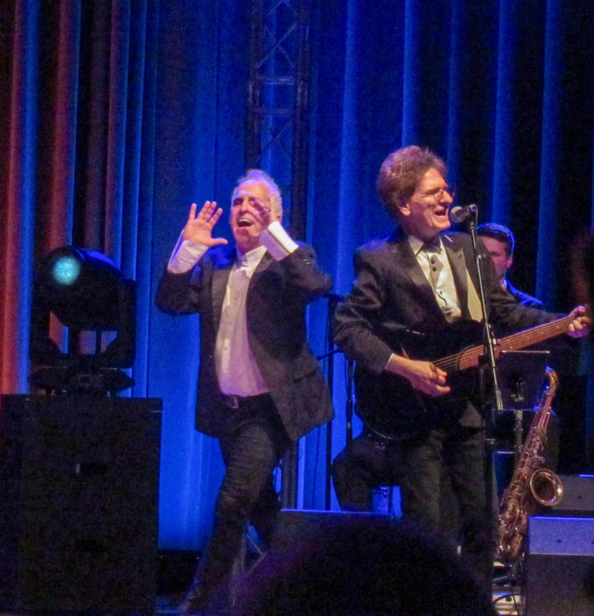 The Weeklings' Glen Burtnik [Left] encourages the crowd to sing along to their first encore song "Hey Jude," while guitarist Bob Burger [Right] performs at The Weeklings Beatles Bash concert in the Dvorak Concert Hall in the Doudna Fine Arts Center on Saturday.