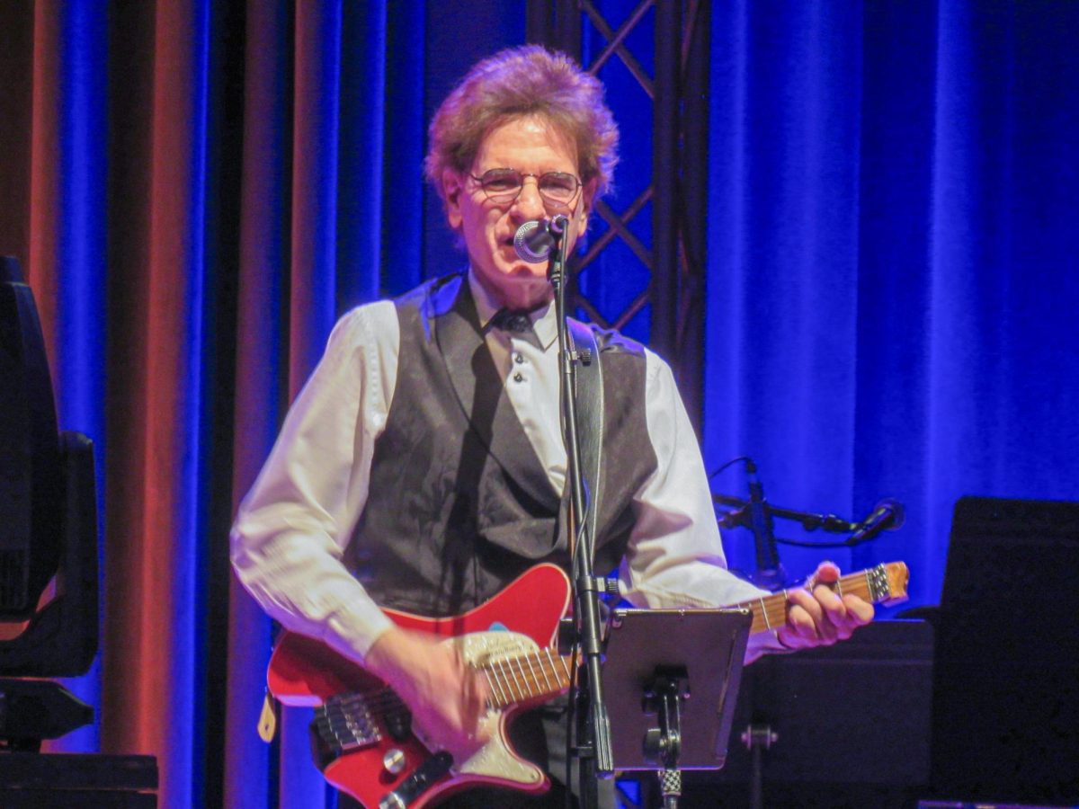 The Weeklings guitarist Bob Burger performs the opening song "A Hard Day's Night," at The Weeklings Beatles Bash concert in the Dvorak Concert Hall in the Doudna Fine Arts Center on Saturday.