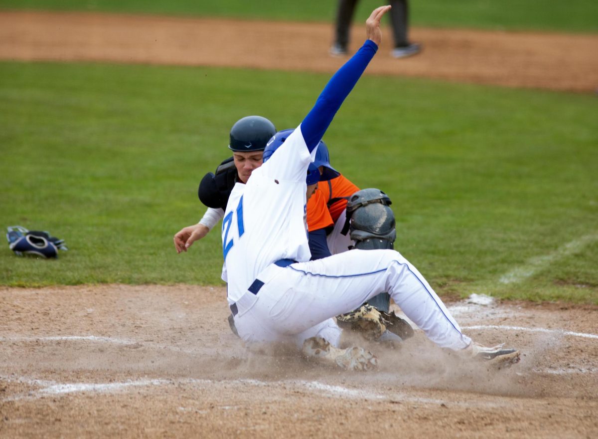 Eastern Illinois University baseball senior infielder Jake Ferguson sliding into home plate in the third inning to put Eastern up 6-1 at Coaches Stadium during Eastern’s win against UT Martin 9-4 after the game got rained out in six innings on Friday.