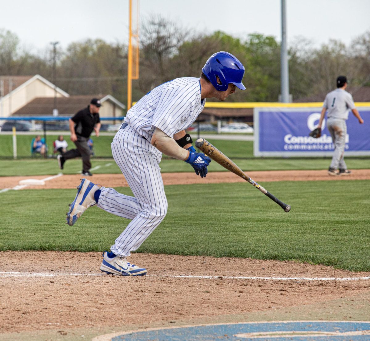 Catcher Redshirt Sophomore Luke Melton throws his bat to the side while he runs to first base,, during  the Baseball game at Coaches Stadium against Illinois Wesleyan Eastern Illinois University won the game with 11-1. April 23,2025 on the EIU campus, Charleston ILL
