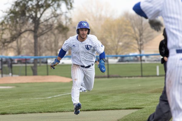 Number 18 infield senior Chris Worcester running to slides into home base during the Eastern Illinois University  panthers against the Saint Xavier cougars at Coaches Stadium on the Eastern Illinois University campus, Charleston Ill. EIU on 13-03