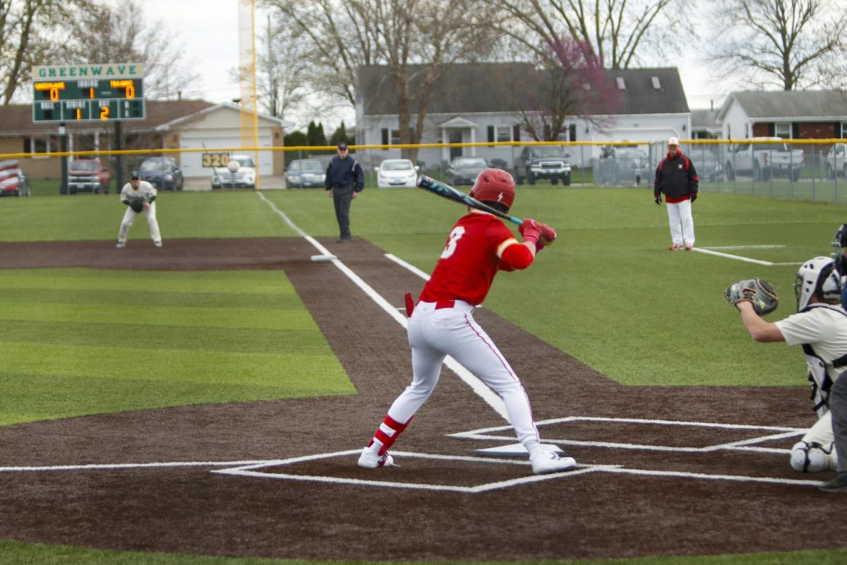 Charleston High School senior Owen Bennett getting ready to swing his bat as the ball comes across the plate in the first inning of the Trojan's first game against Mattoon as Charleston lost both games 12-8 and 5-4 on Monday April 7.