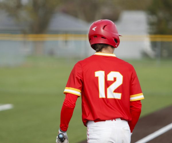 Charleston High School sophomore Russell Applegate stepping into the batter's box during game one of the Trojans' doubleheader against the Mattoon Greenwave as Charleston lost both games 12-8 and 5-4 on Monday April 7.