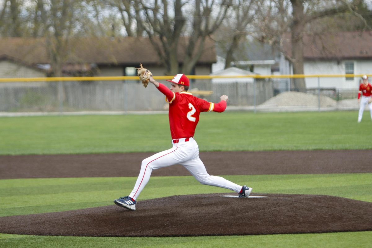 Charleston High School senior Luke Bonnstetter delivering a pitch against the Mattoon Greenwave during the Trojan's first game against Mattoon as Charleston lost both games 12-8 and 5-4 on Monday April 7.