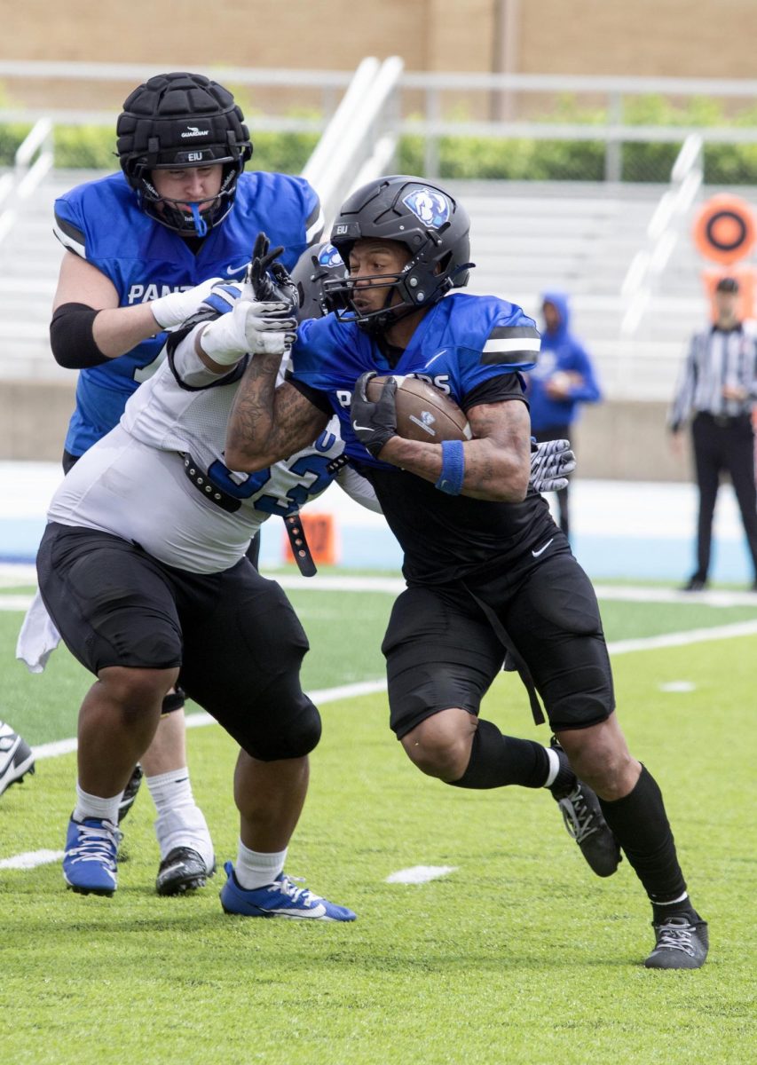 Eastern Illinois football redshirt junior running back Jay Pearson running through contact down the middle of the field during Eastern’s spring game as the offense beat the defense 43-42 at O’Brien field on Saturday.