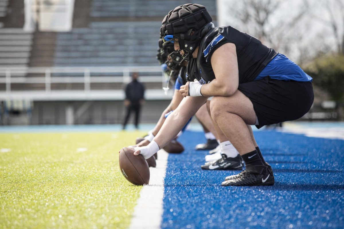 Redshirt sophomore offensive lineman, Panayiotis Mihalopoulos, lines up with the offensive line with the ball to throw it back during football practice at O'Brien Field on April 10.