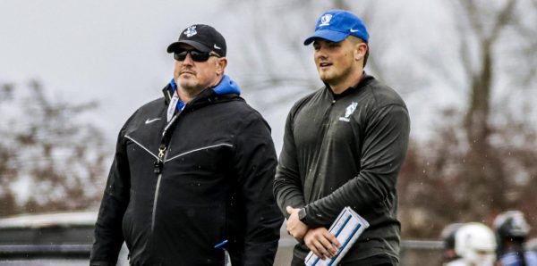 [THUMBNAIL EDITION] (From left to right) Head football coach Chris Wilkerson works with his son student assistant coach Peyton Wilkerson at football practice at O'Brien Field on the Eastern Illinois University campus on Thursday.