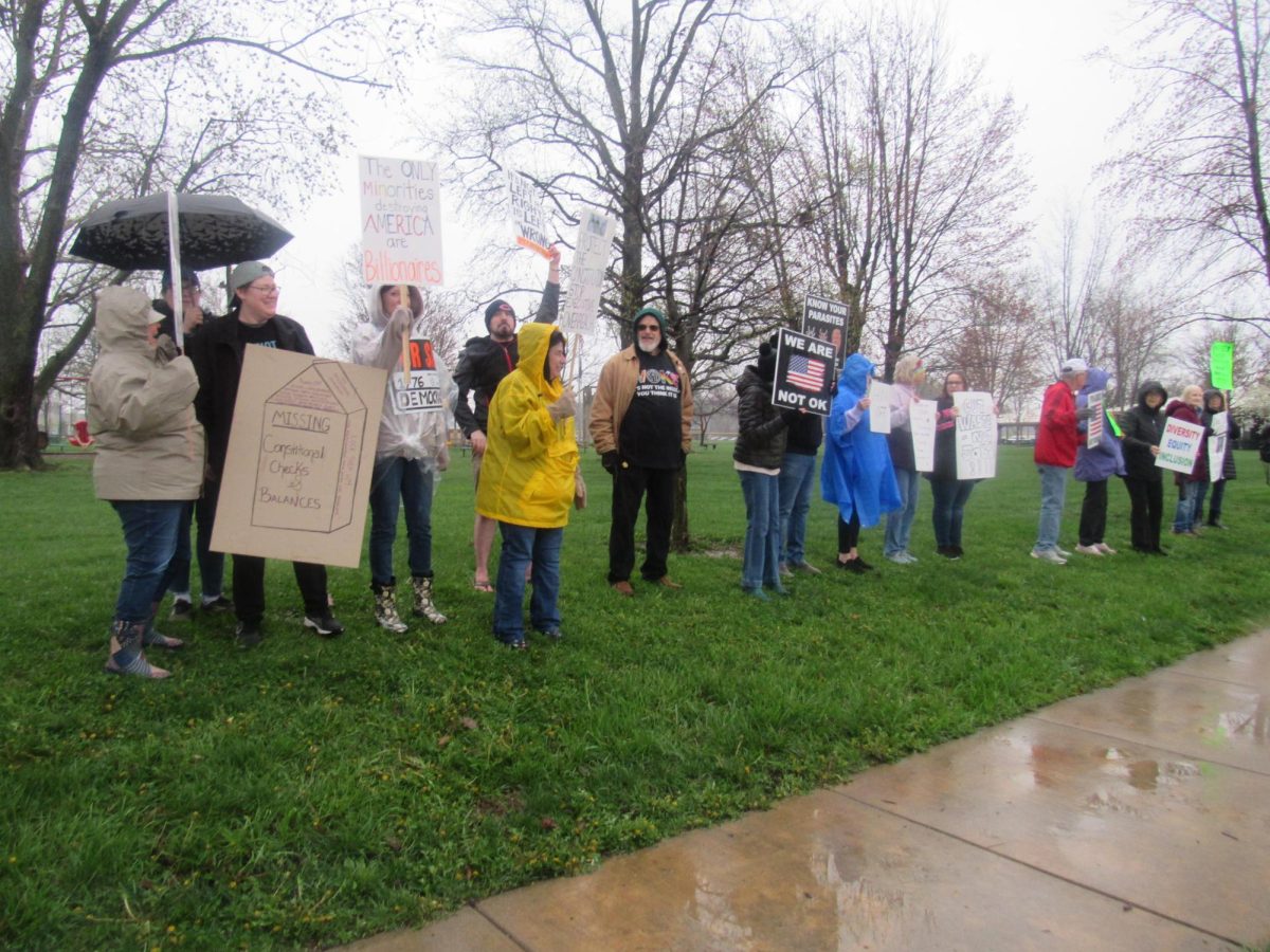 Protesters participating in the Hands Off! Mobilization at the edge of Morton Park along Lincoin Avenue on Saturday. Hands Off! is a movement centered around country wide protesting on April fifth of President Donald Trump and Department of Government Efficiency head Elon Musk's actions in the federal government.