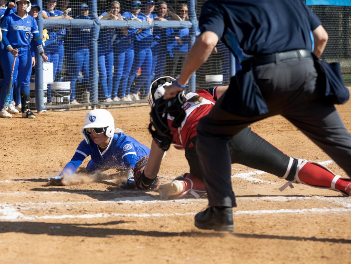Eastern Illinois softball senior outfielder Sophie Cerveny sliding into home plate as she gets called out during Eastern’s loss to Southern Illinois University Edwardsville 3-1 on senior day at Williams field on Saturday.