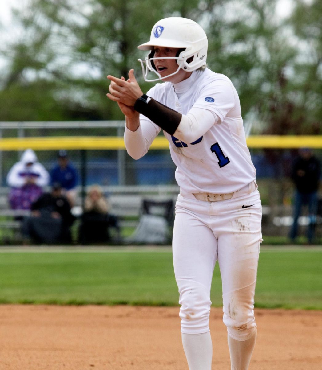 Eastern Illinois softball senior outfielder Abbey Crain clapping on first base after her hit during the first game of Eastern’s double header against Southern Illinois University Edwardsville at Williams field on Sunday.