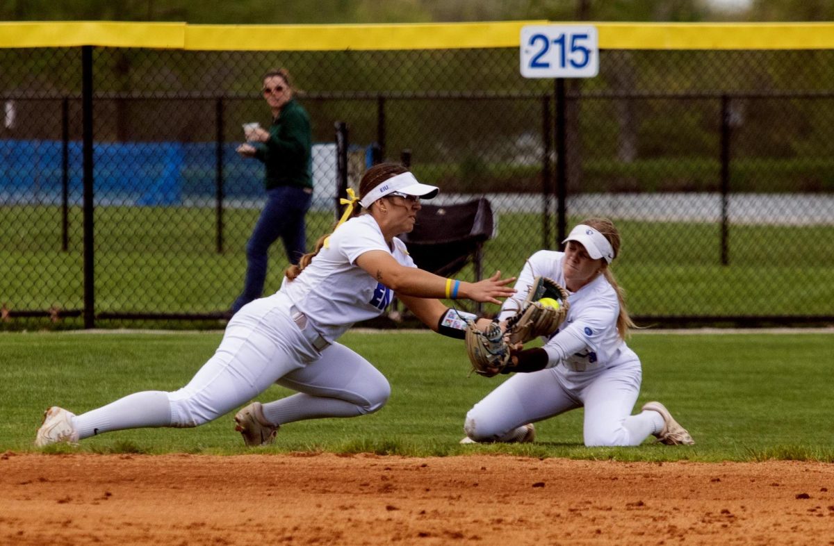 Eastern Illinois softball senior infielder Briana Gonazlez (left) and sophomore infielder Alisha Frederick (right) colliding as they both try and catch a fly ball during the first game of Eastern’s double header against Southern Illinois University Edwardsville at Williams field on Sunday.