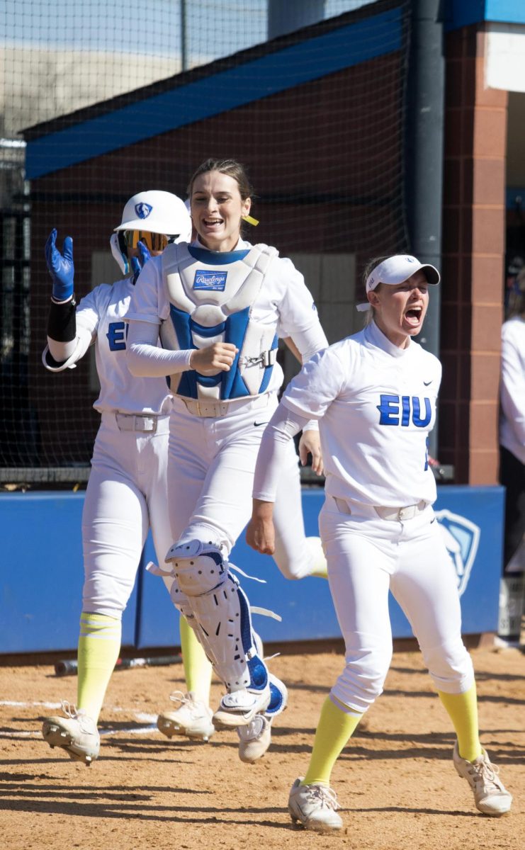 Eastern Illinois fifth year utility player Abbey Crain and sophomore catcher Sophia Olman celebrating sophomore infielder Alisha Frederick’s home run hit in the third inning during its annual care game and Eastern softball’s win against Southern Indiana 5-2 at Williams field on Saturday April 12.