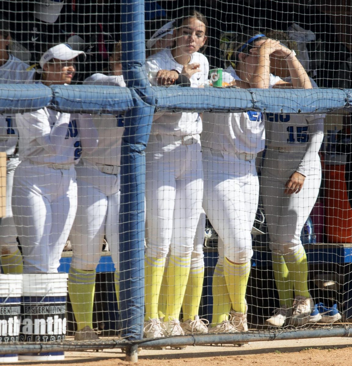 Eastern Illinois softball players wearing yellow socks and bows while in the dugout for the Eastern care game for Sarcoma during Eastern’s win against Southern Indiana 5-2 at Williams field on Saturday April 12.