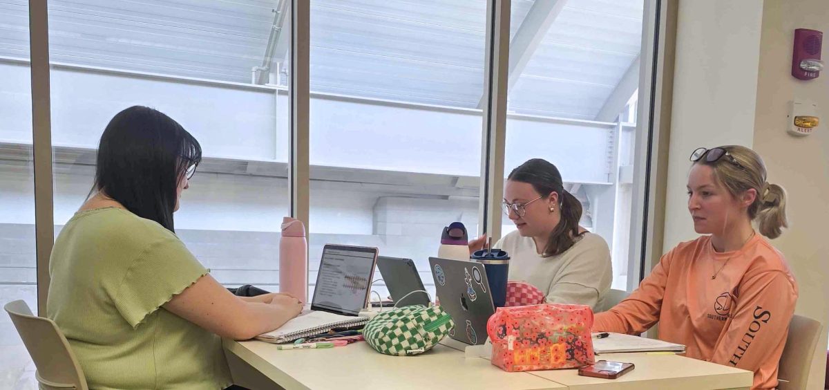 Senior biology and pre veterinarian major Autumn Cohan (Left), senior biology major Annie Toberman (Back right), and junior biology major Katie Clatfelter (Near right) our all studying for their respective tests and classes on the third floor of Booth Library on Friday March 14.