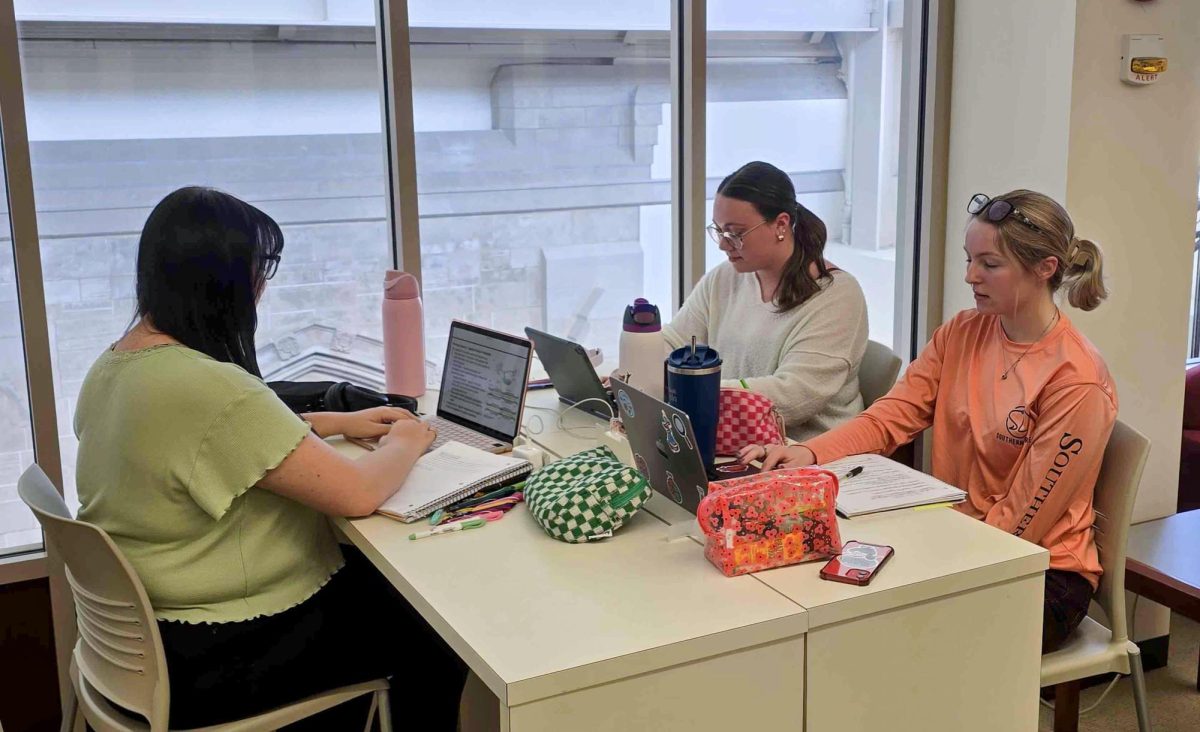 Senior biology and pre veterinarian major Autumn Cohan (Left), senior biology major Annie Toberman (Back right), and junior biology major Katie Clatfelter (Near right) our all studying for their respective tests and classes on the third floor of Booth Library on Friday March 14.