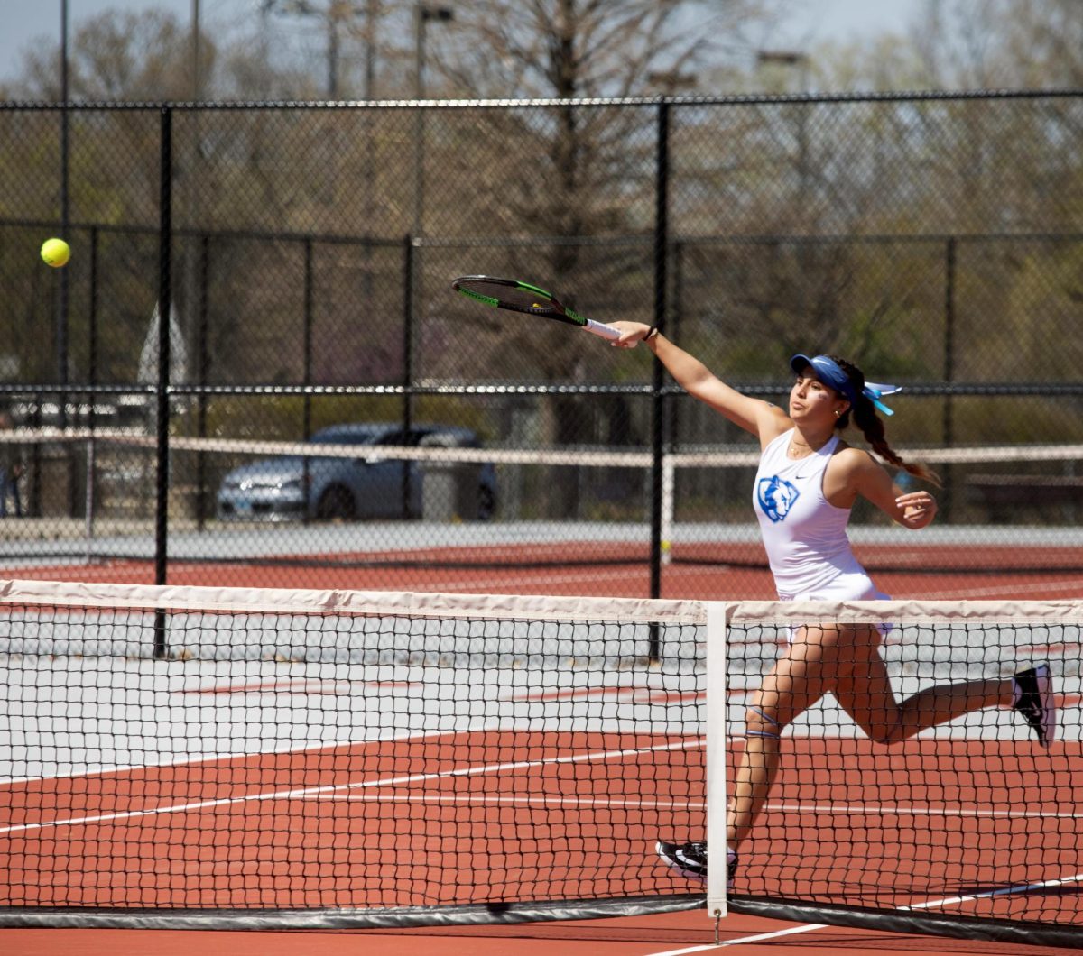 Eastern Illinois women’s tennis senior Luisa Renovales Salazar hitting a shot over the net during her doubles match at the Charleston High School tennis courts where Eastern beat Southern Illinois University Edwardsville 4-3 on Senior night on Saturday April 12.