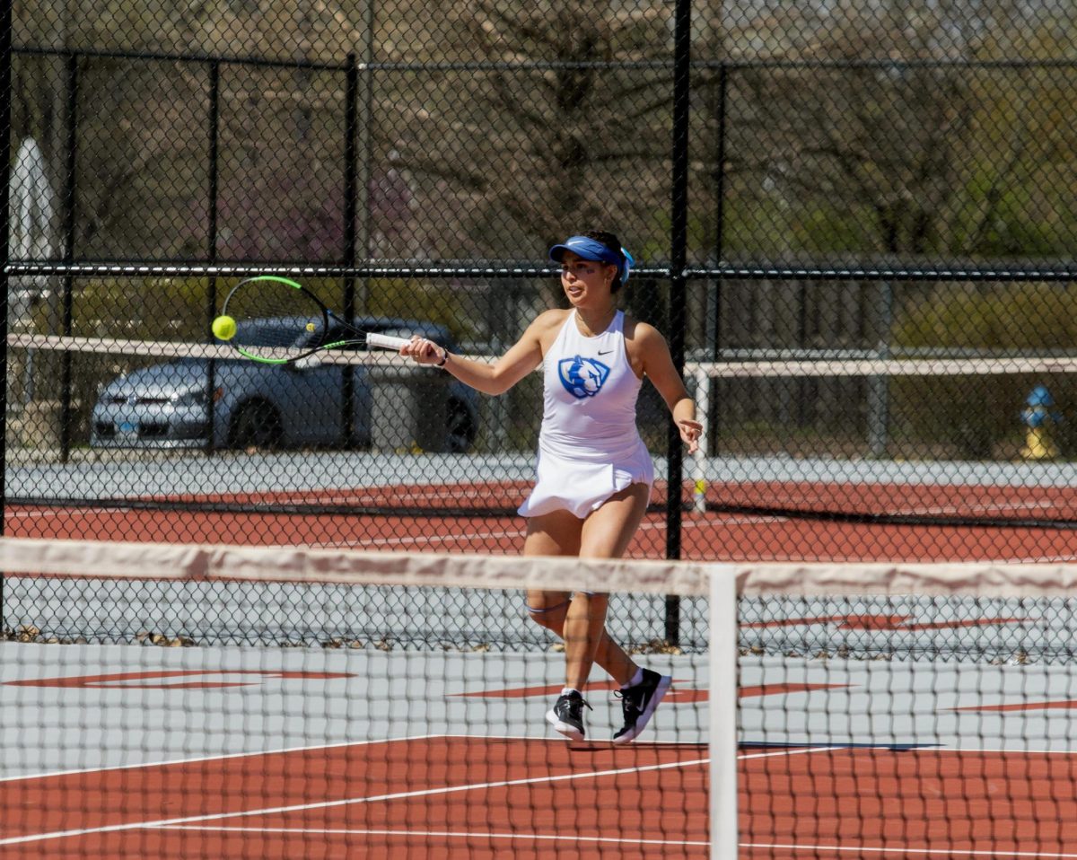 Eastern Illinois women’s tennis senior Luisa Renovales Salazar hitting a shot over the net during her doubles match at the Charleston High School tennis courts where Eastern beat Southern Illinois University Edwardsville 4-3 on Senior night on Saturday April 12.