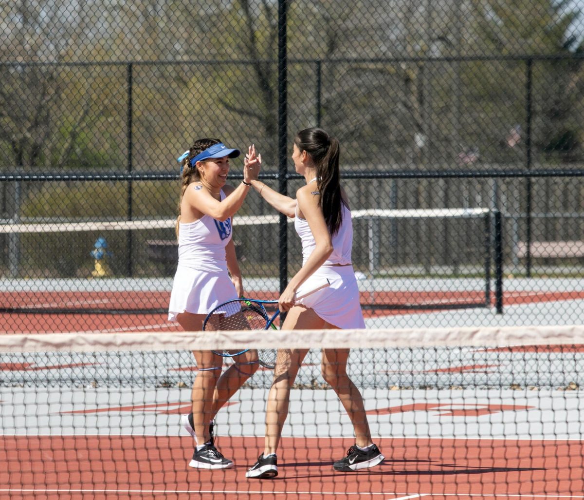 Eastern Illinois women’s tennis senior Luisa Renovales Salazar and her double partner sophomore Michelle Kostadinova high fiving during their doubles match at the Charleston High School tennis courts where Eastern beat Southern Illinois University Edwardsville 4-3 on Senior night on Saturday April 12.